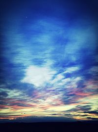 Scenic view of sea against cloudy sky at sunset