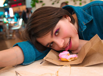 Close-up portrait of a smiling girl lying on table