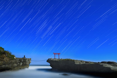 Star trails over torii gate in the sea at shirahama shrine, izu peninsula, japan