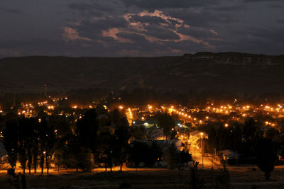 Illuminated city against sky at night