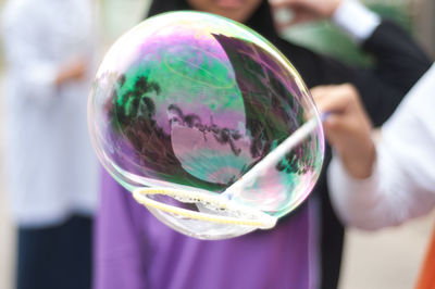 Close-up of hand holding bubbles