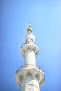 Low angle view of lighthouse against clear blue sky