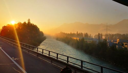 Scenic view of river against sky during sunset