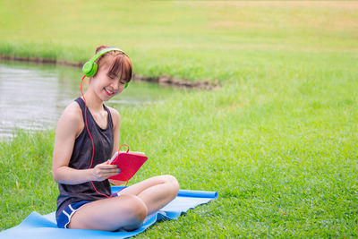 Young woman sitting on book