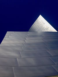 Low angle view of buildings against clear blue sky