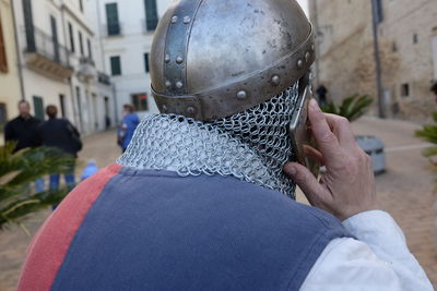 Rear view of man wearing helmet while talking on phone