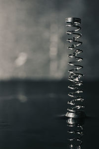 Close-up of metallic structure in sea against sky