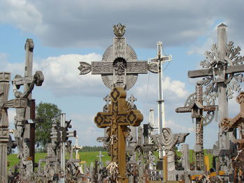 Crosses in cemetery against sky