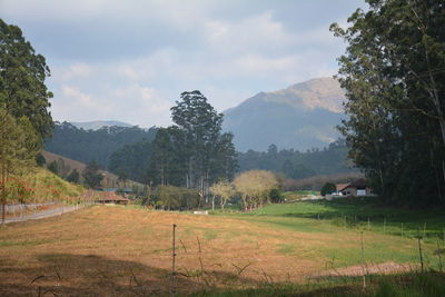 Scenic view of mountains against cloudy sky