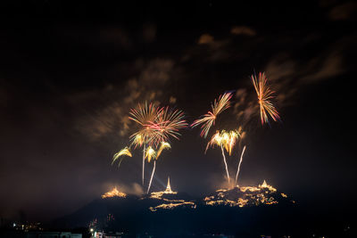 Low angle view of firework display at night