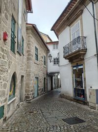 Empty alley amidst buildings in city