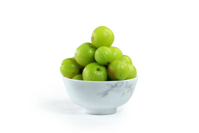 Close-up of fruits in bowl over white background