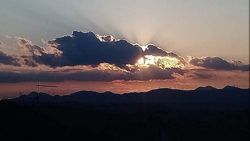 Scenic view of silhouette mountains against sky during sunset