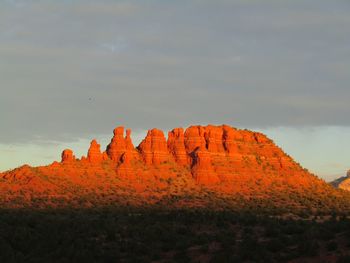 Scenic view of morning light on rock formation against sky