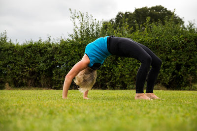 Full length of senior man on field against trees