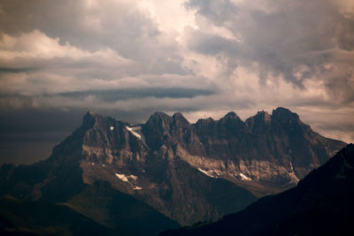 Scenic view of mountains against cloudy sky