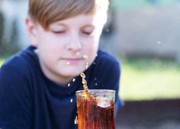 Close-up portrait of boy drinking glass