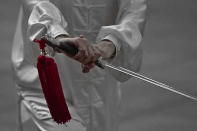 Midsection of man working with umbrella