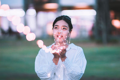 Close-up portrait of young woman standing outdoors