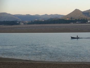 Scenic view of sea with mountains in background