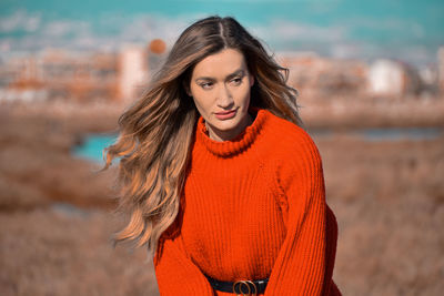 Portrait of beautiful young woman standing outdoors