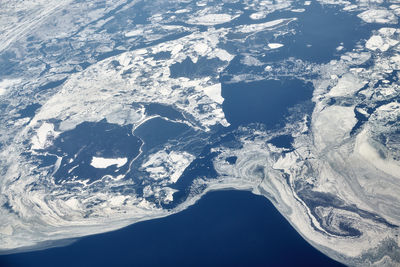 Aerial view of snowcapped mountains against sky