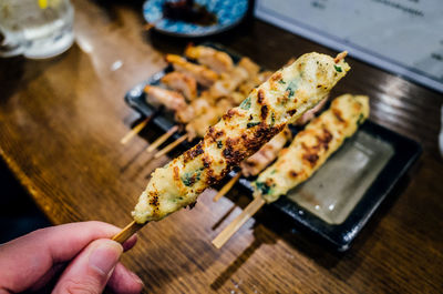 Close-up of hand holding food on table