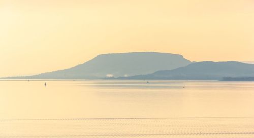 Scenic view of sea against clear sky during sunset