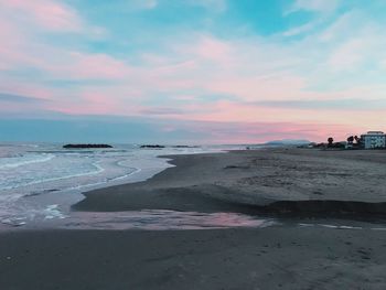 Scenic view of beach against sky during sunset