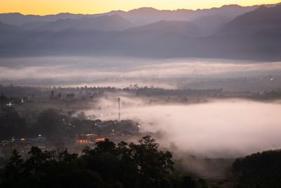 High angle view of trees and mountains against sky during sunset