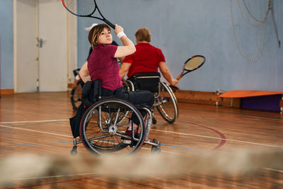 Side view of man with bicycle on floor