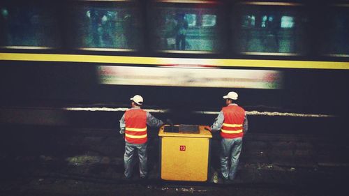 Rear view of man standing in train