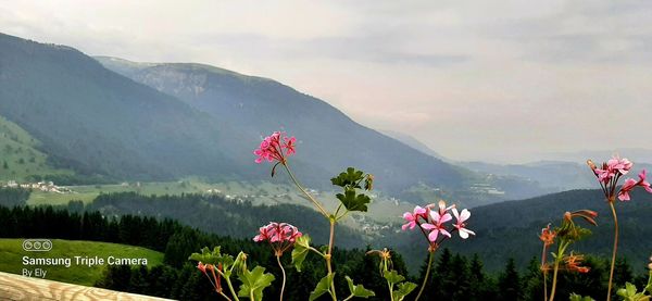 Scenic view of mountains against cloudy sky