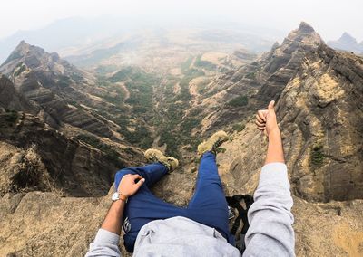 Low section of man with woman on mountain