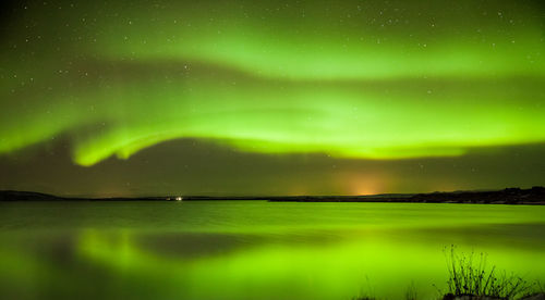 Scenic view of lake against sky at night