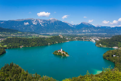 Scenic view of lake and mountains against blue sky