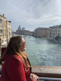 Woman looking at view of city buildings against sky