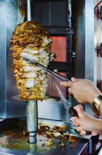 Cropped hands cutting shawarma