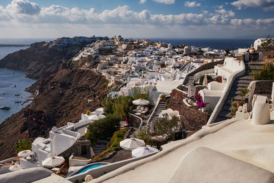 High angle view of townscape by sea against sky