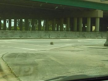 Empty parking lot seen through glass window
