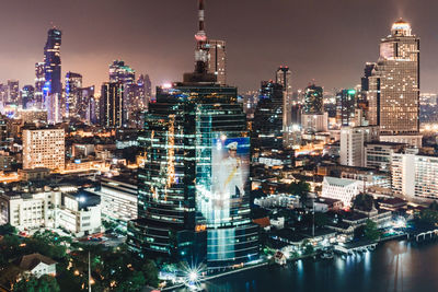 Aerial view of illuminated buildings in city at night