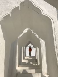 Woman standing on staircase of building