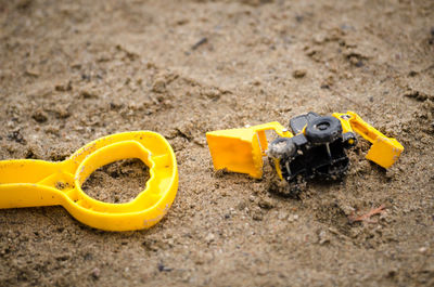 High angle view of yellow toys on field