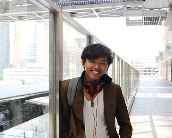 Portrait of young man standing in office