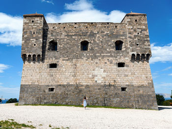 Nehaj, senj, croatia. woman stading in front of medieval fort.