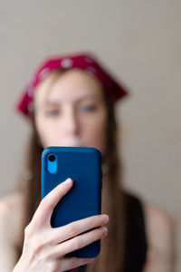 Closeup image of a beautiful  woman holding , using and looking at smart phone 