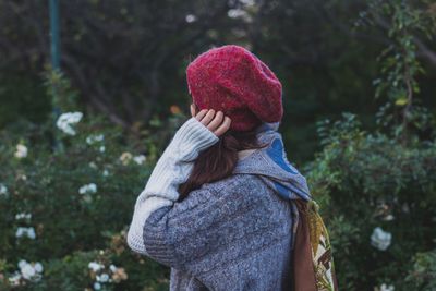 Side view of young woman knit hat