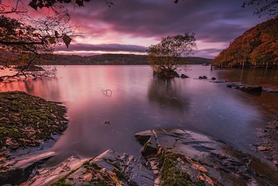 Scenic view of lake against sky at sunset