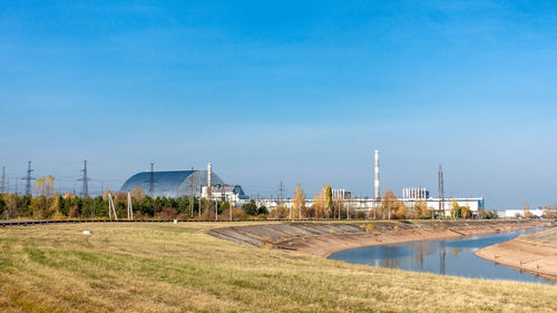 Built structure on field against blue sky