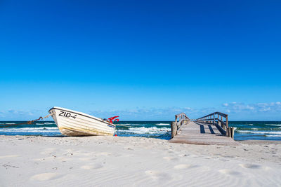 Scenic view of beach against clear blue sky